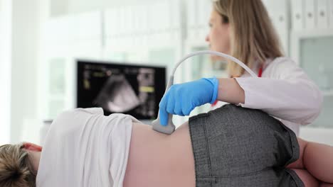 medical professional performing ultrasound examination on patient's back