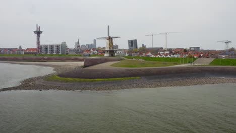 Aerial-low-altitude-shot-of-a-beautiful-windmill-Oranjemolen-in-Vlissingen,-Zeeland,-The-Netherlands