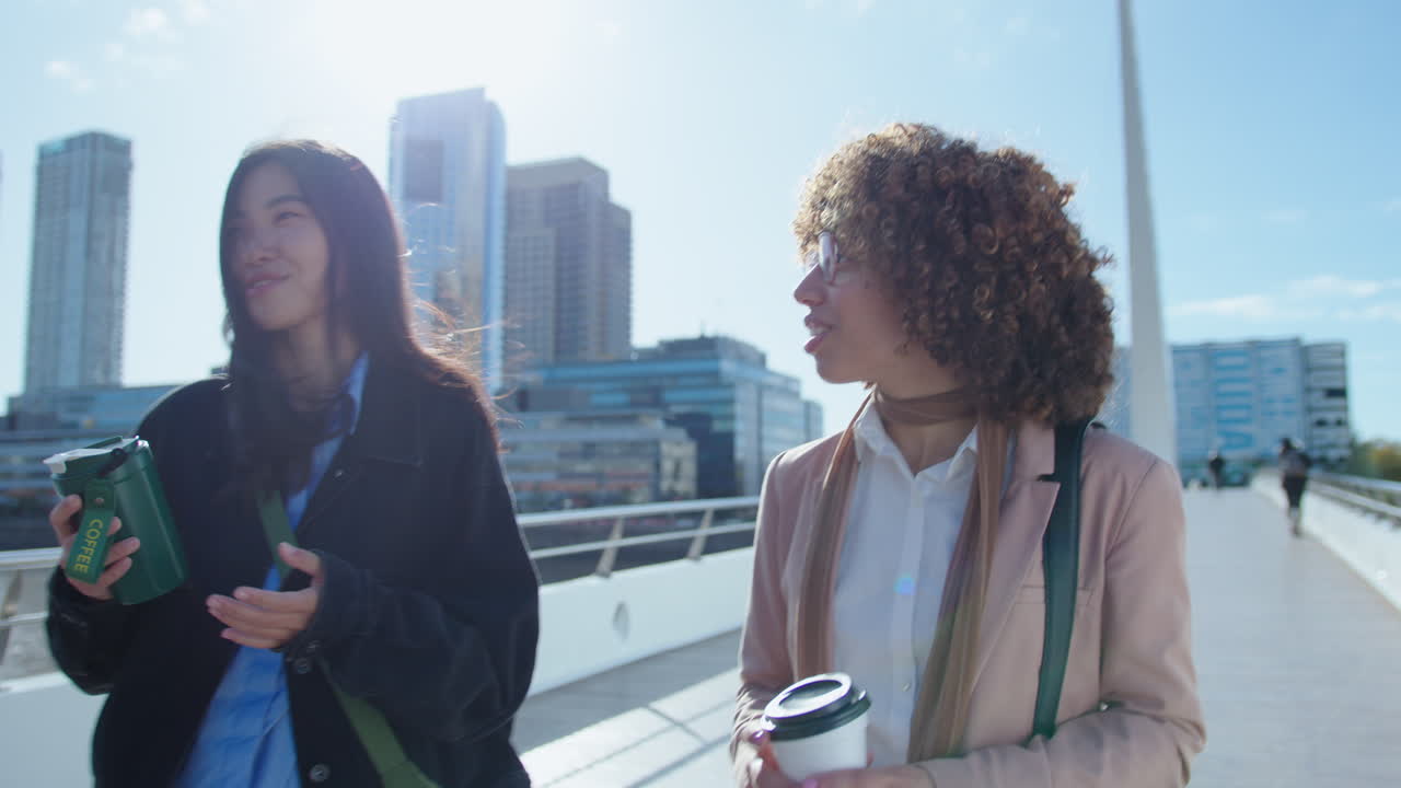 Female Friends Walking in the City and Having Talk
