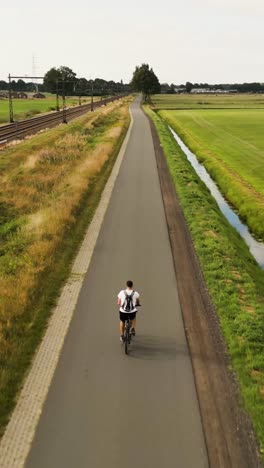 man cycling on a country road