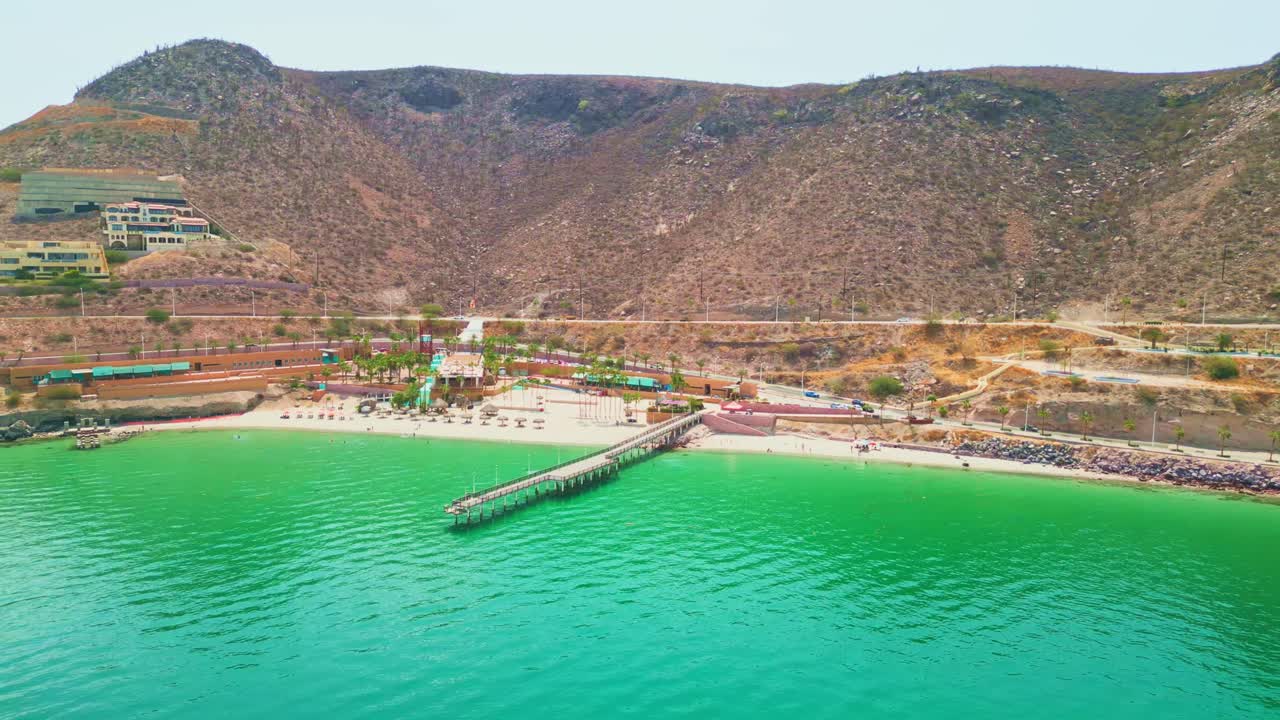 Playa coromuel beach in la paz, showcasing crystal-clear waters and mountainous surroundings, aerial view
