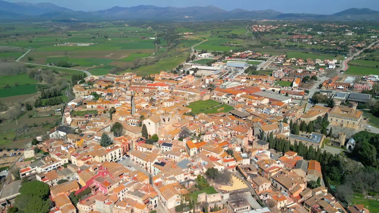 Peralada aerial view revealing peralada's medieval charm, with castell de peralada nestled among terracotta rooftops and verdant countryside landscape
