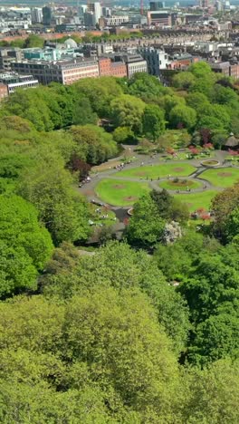social ratio aerial video of the grounds of of st stephen's green and the dublin cityscape on a bright and sunny day. filmed in 1080x1920 and with rec709 color