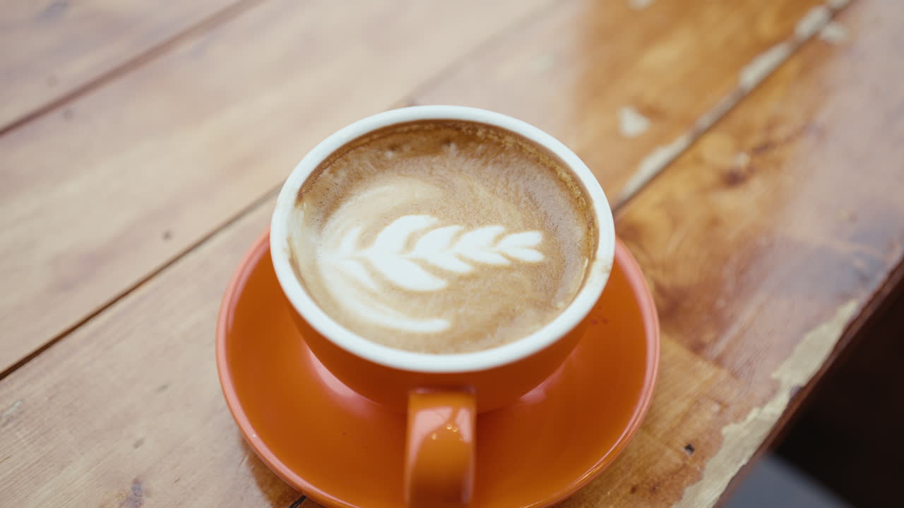 Orange Cup of Latte Art Coffee