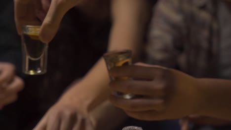 people-taking-shots-of-whiskey-in-a-party