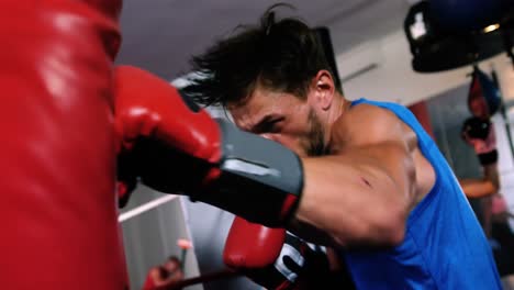 Boxer-practicing-boxing-with-punching-bag