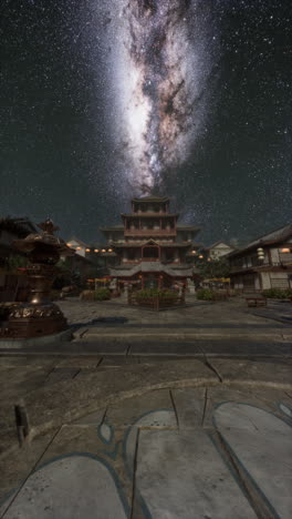 night sky with milky way over traditional japanese temple complex