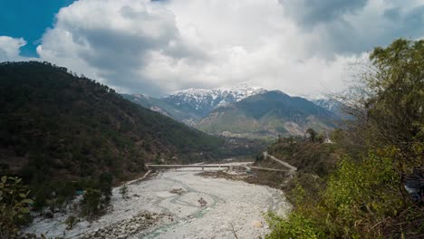 timelapse video of clouds moving over a river and the mountains near palampur, in the indian state of himachal pradesh.