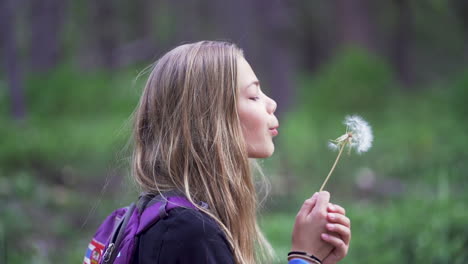 Slow-Motion,-Side-Profile,-Rack-Focus,-Young-Blonde-Girl-Blows-Dandelion