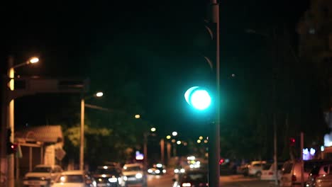 traffic at night stopping at a stop light waiting for it to turn green