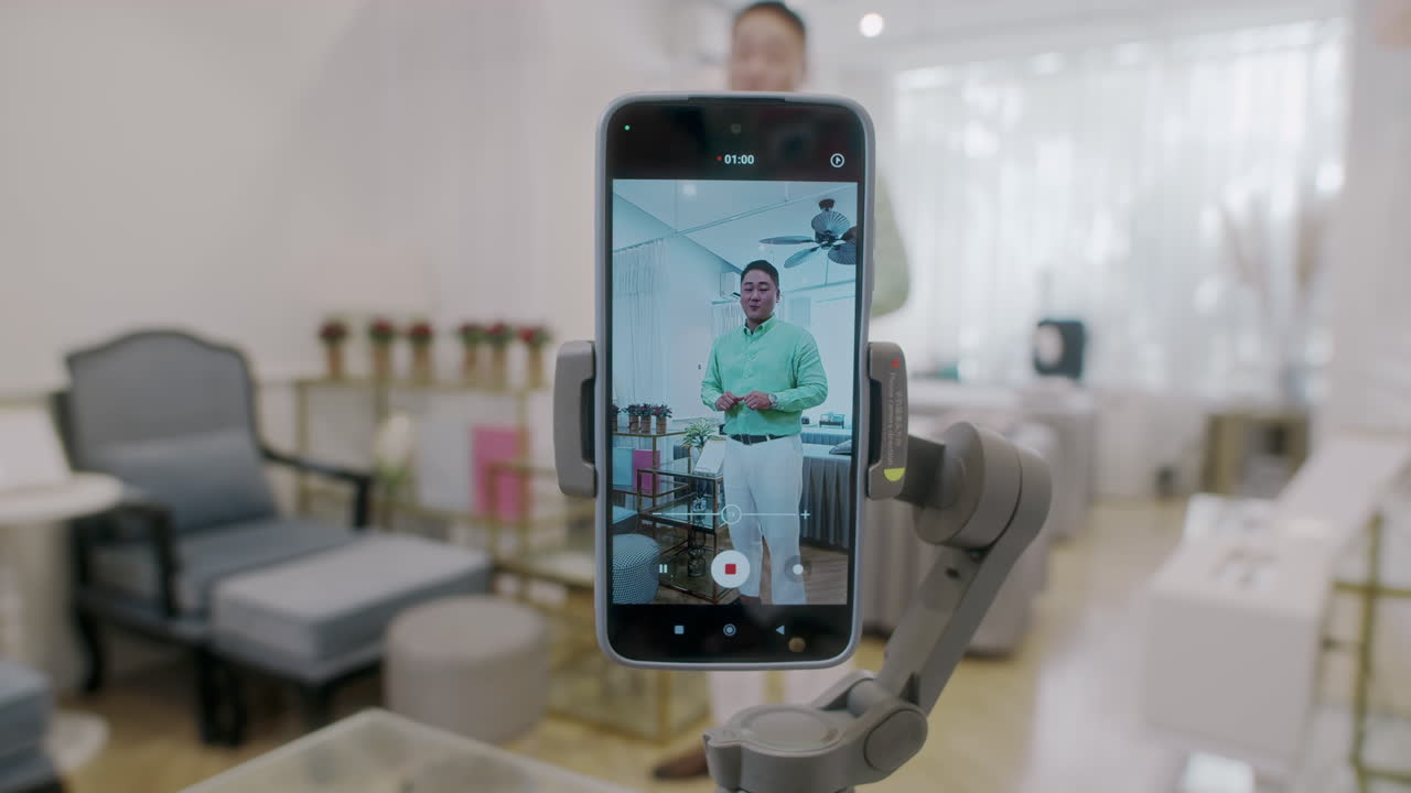 Phone in Tripod Filming Man Talking about Wax Salon