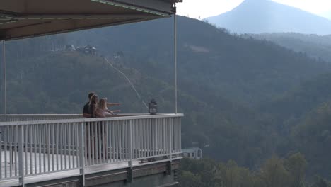 drone footage of tourist family on scenic mountain overlook