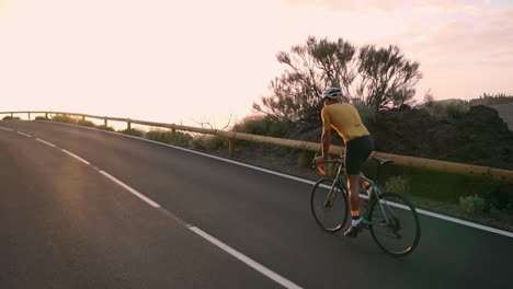 in slow motion, the athlete on a bike rides a mountain serpentine, relishing the island's view, epitomizing a dedication to a healthy lifestyle