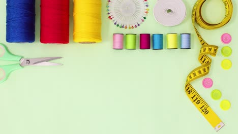 sewing and knitting threads, buttons scissors and other items appear on the top. stop motion