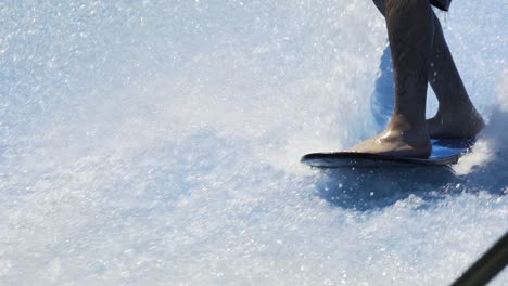 Man-struggles-to-balance-while-surfing-a-wave-machine