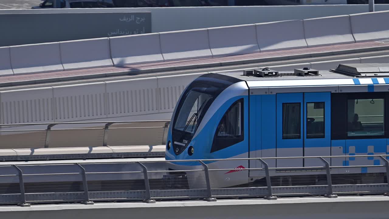 A close-up of a Dubai Metro train as it heads to its next stop along Sheikh Zayed Road in Dubai, UAE