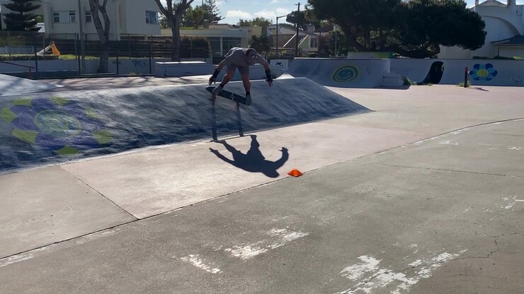 Young man playing skateboard sweeping turns on surf skate on empty park or street road, control motion balancing movement extreme outdoor activity with skills. People lifestyle recreation