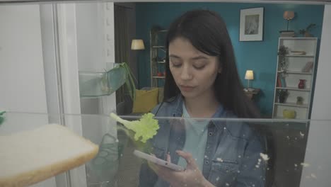 woman looking inside an empty refrigerator