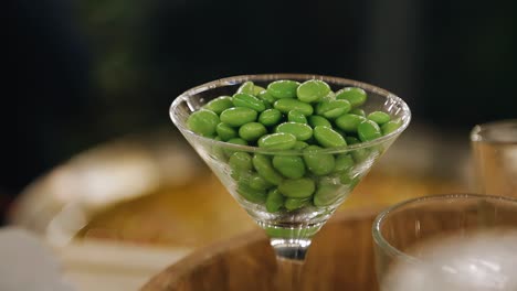 there are green lollipops in the glass. taking a close-up of a treat