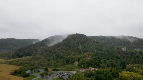 flying towards mystical mountain top enveloped in fog