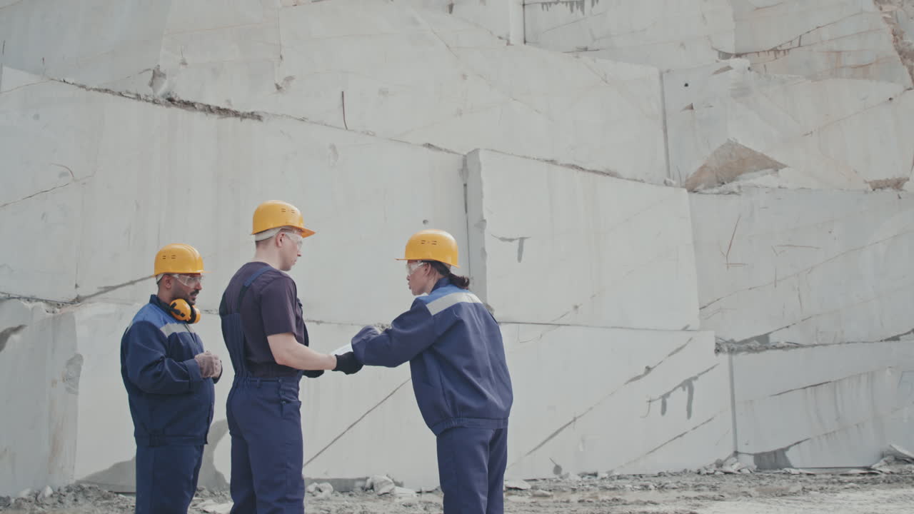 Female Worker Instructing Colleagues in Granite Quarry