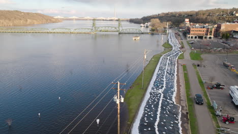 Large-sandbag-barrier-along-flooded-river-protects-city-infrastructure-from-water-damage