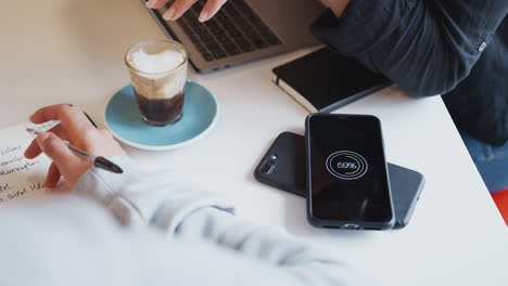 close up of two mobiles phone to phone wirelessly charging on desk