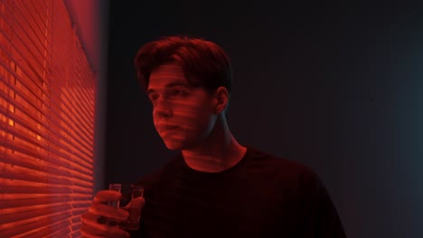 young man drinking alone at night