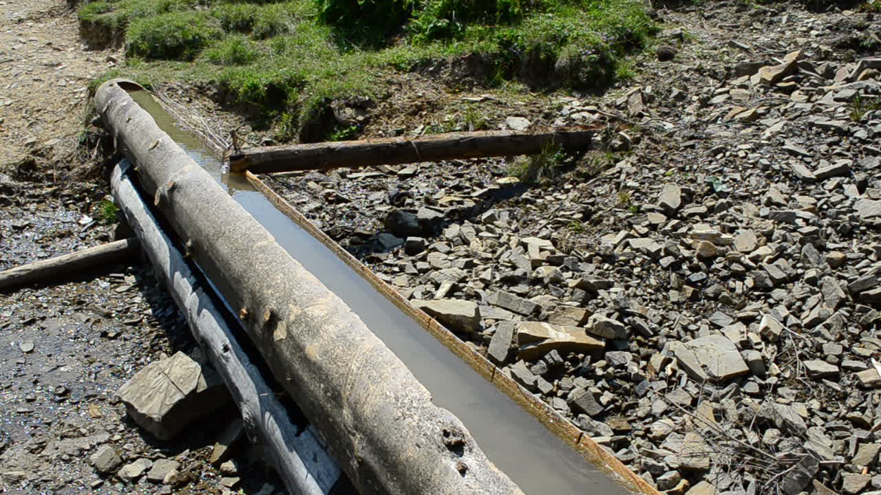 Summer in mountains, a mountain spring, a construction. Mountain spring