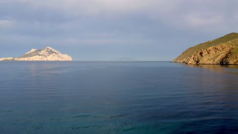 dramatic footage of drone camera flying between two rocks, greece