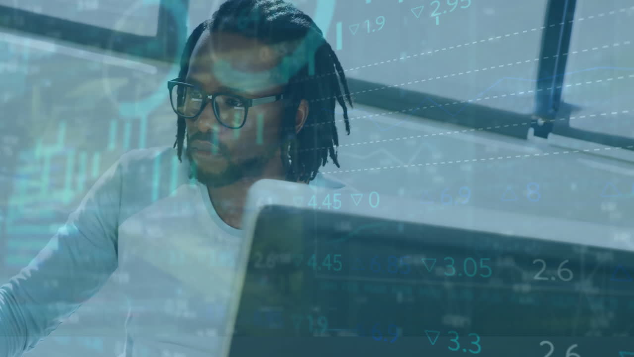 Animation of infographic interface over african american businessman with dreadlocks using computer