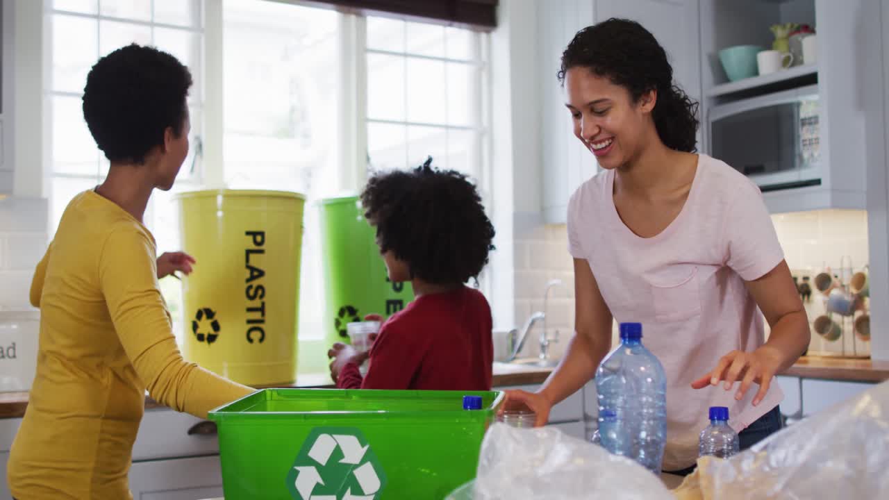Mixed race lesbian couple and daughter cleaning kitchen