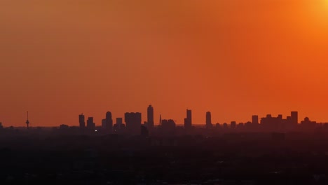 sunset over rotterdam: city skyline in orange hues