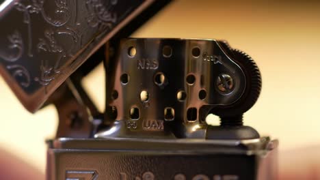 close-up of a metal lighter mechanism: intricate design featuring holes, spring, and imprinting for optimal functionality and durability in everyday use