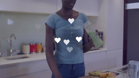 sosteniendo un batido verde, mujer en la cocina con iconos de corazón animación más