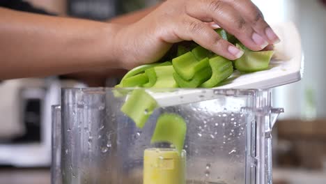 Dumping-sliced-celery-into-the-food-processor-to-mince-in-preparation-for-a-gumbo-recipe---slow-motion-GUMBO-SERIES