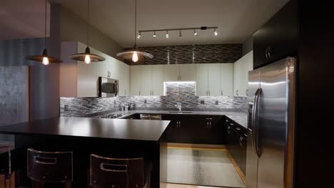 wide push-in shot of a modern kitchen with white and black cabinets