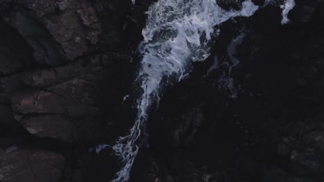 ocean water moving through rocks