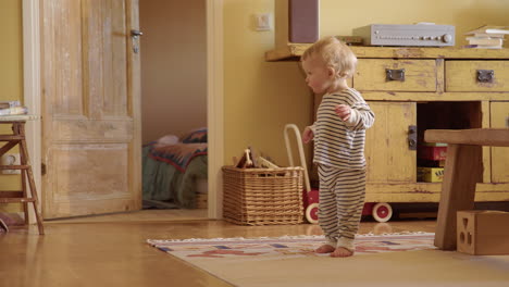 cute toddler learning to walk, interior shabby chic colourful house