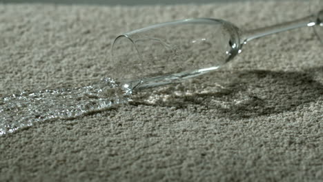 wine glass of water spilling on carpet