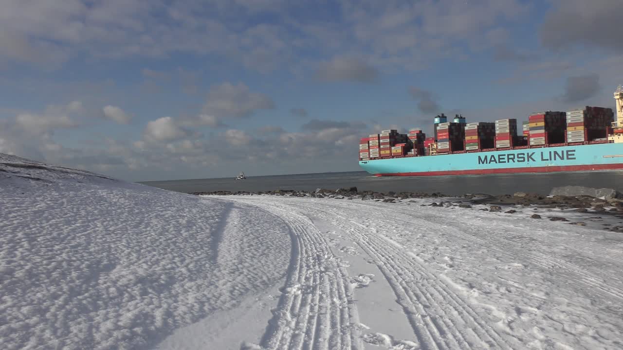 Container Ship Of Maersk Line Sailing Inbound To Port Of Rotterdam, Netherlands On A Sunny Winter Day. wide shot