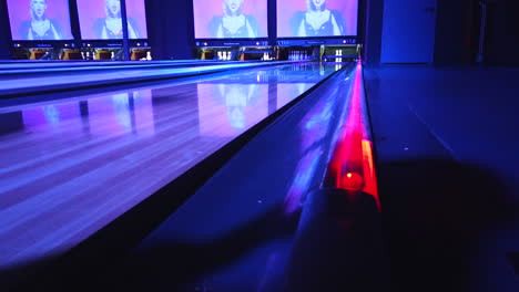 a failed shot at executing a strike during neon night at the local bowling alley