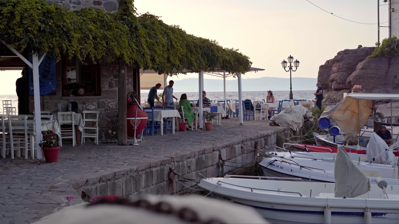 Tourists in luxury Greek cafe with sea view, Lesvos Island