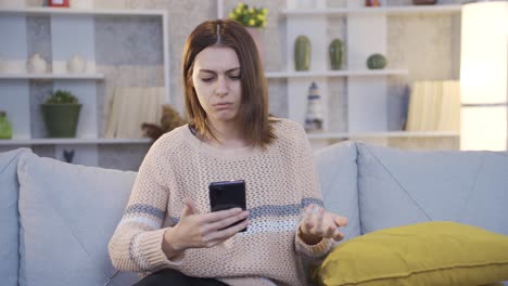 Young-woman-Using-Smartphone-Gets-Sad-and-Surprised-by-Bad-News.