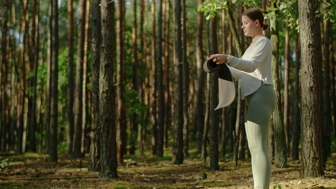 Woman Preparing for Yoga in Forest