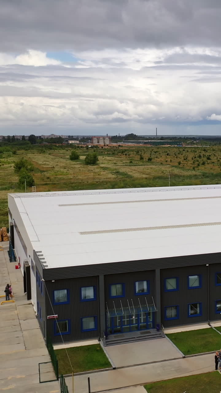 Aerial view of industrial building. View of the industrial district from the air Vertical video