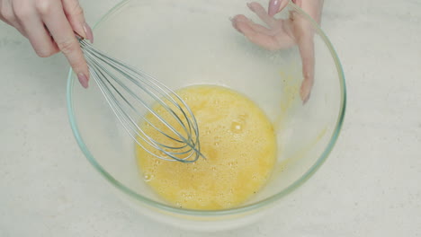 preparing eggs by hand mixing
