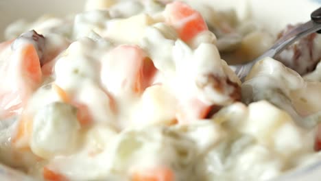 close-up of a bowl of potato salad with fork