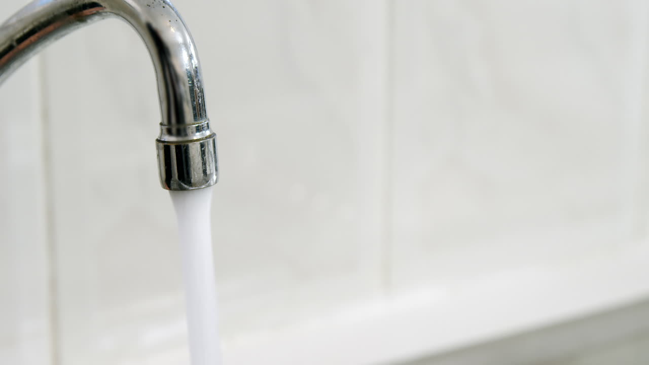 Tap of running water in kitchen sink