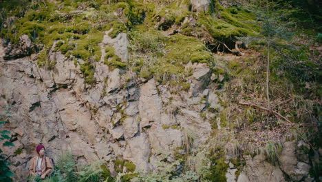 Young-Hiker-Standing-Near-Rocky-Surface-In-Forest